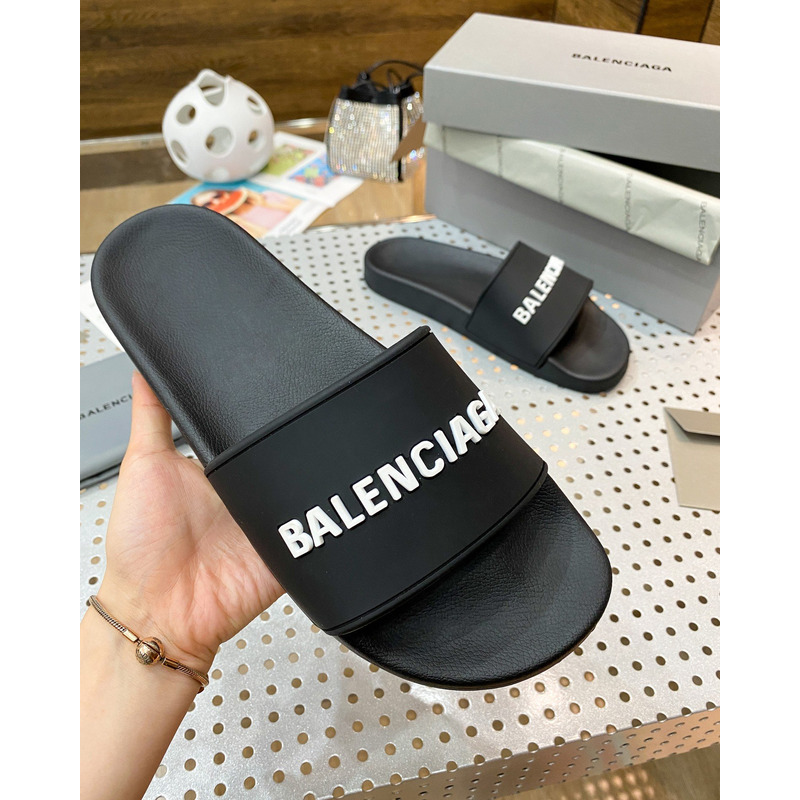 Ba*len*cia*ga pool slide sandal in black rubber with white 3d Ba*len*cia*ga logo