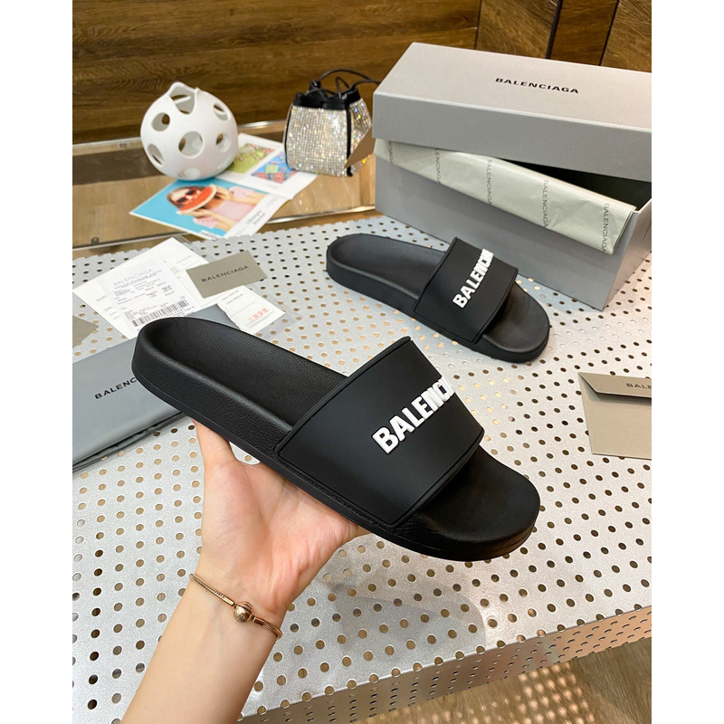 Ba*len*cia*ga pool slide sandal in black rubber with white 3d Ba*len*cia*ga logo