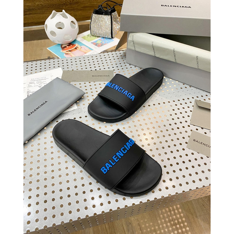 Ba*len*cia*ga pool slide sandal in black rubber with blue 3d Ba*len*cia*ga logo