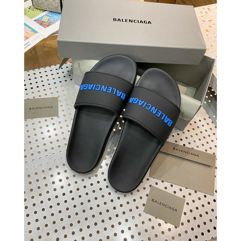 Ba*len*cia*ga pool slide sandal in black rubber with blue 3d Ba*len*cia*ga logo