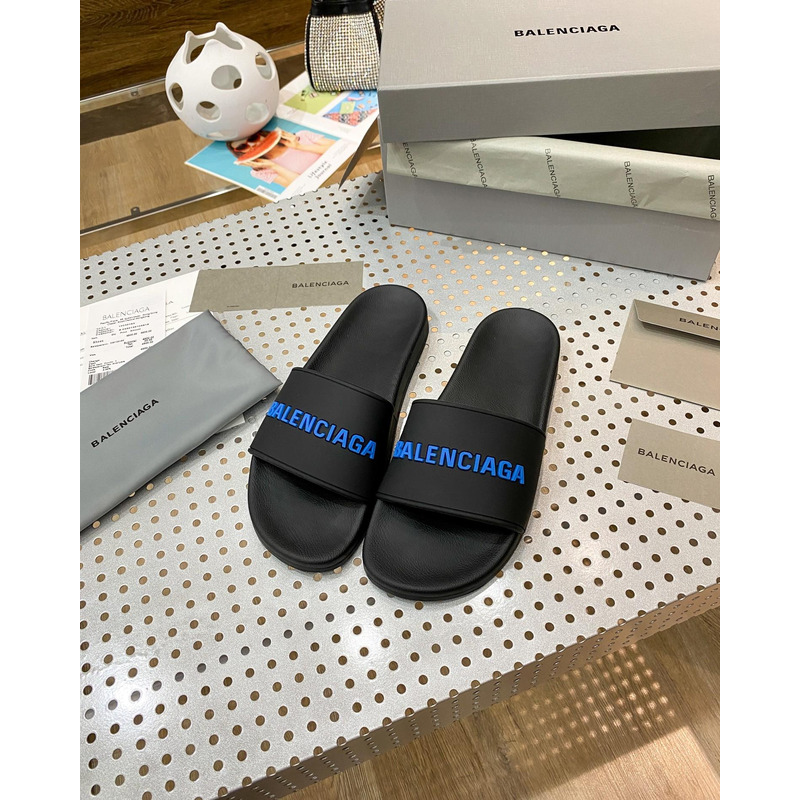 Ba*len*cia*ga pool slide sandal in black rubber with blue 3d Ba*len*cia*ga logo