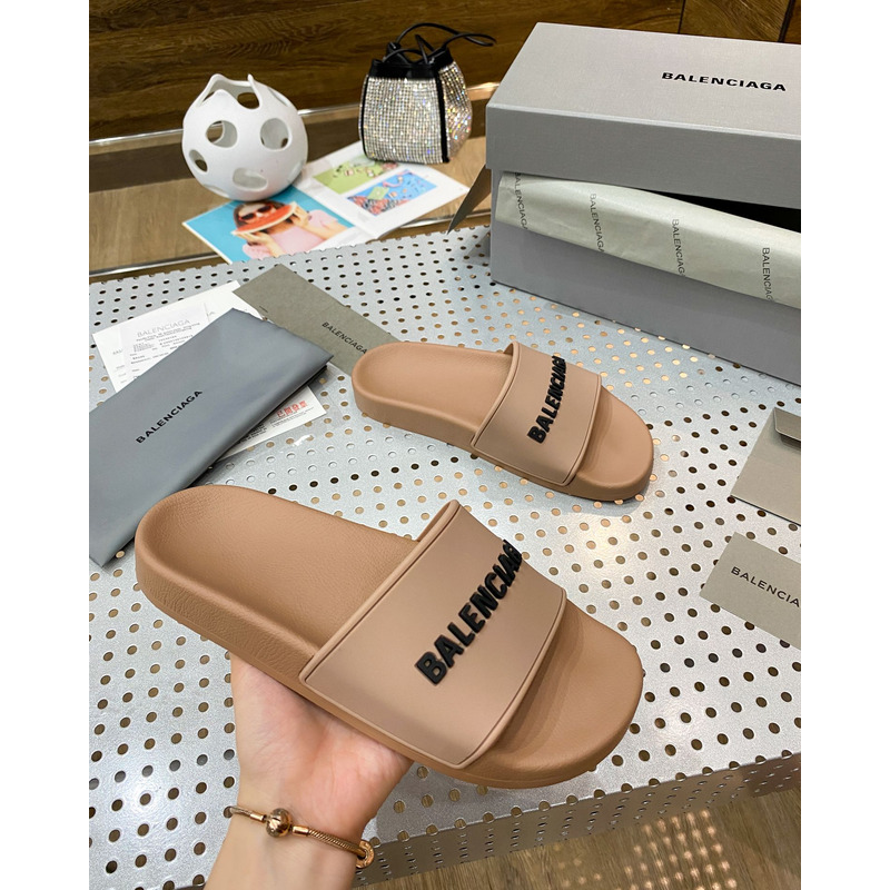 Ba*len*cia*ga pool slide sandal in beige smooth rubber with black 3d Ba*len*cia*ga logo