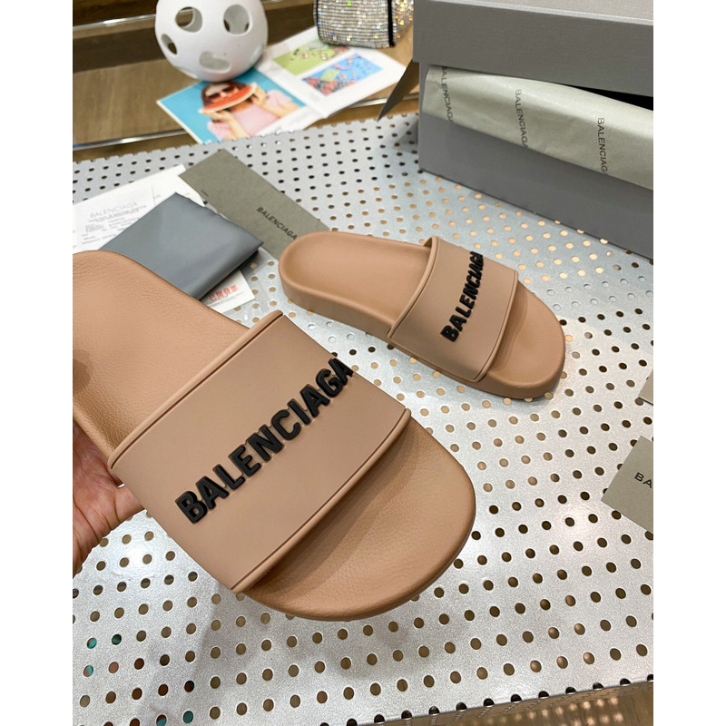 Ba*len*cia*ga pool slide sandal in beige smooth rubber with black 3d Ba*len*cia*ga logo