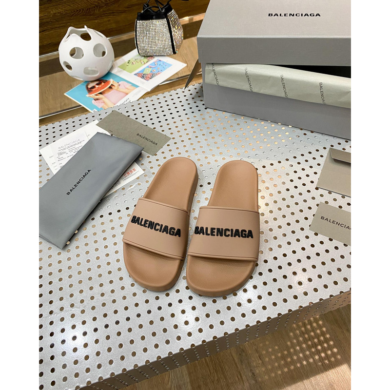 Ba*len*cia*ga pool slide sandal in beige smooth rubber with black 3d Ba*len*cia*ga logo