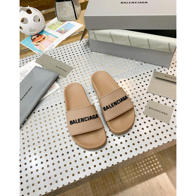 Ba*len*cia*ga pool slide sandal in beige smooth rubber with black 3d Ba*len*cia*ga logo