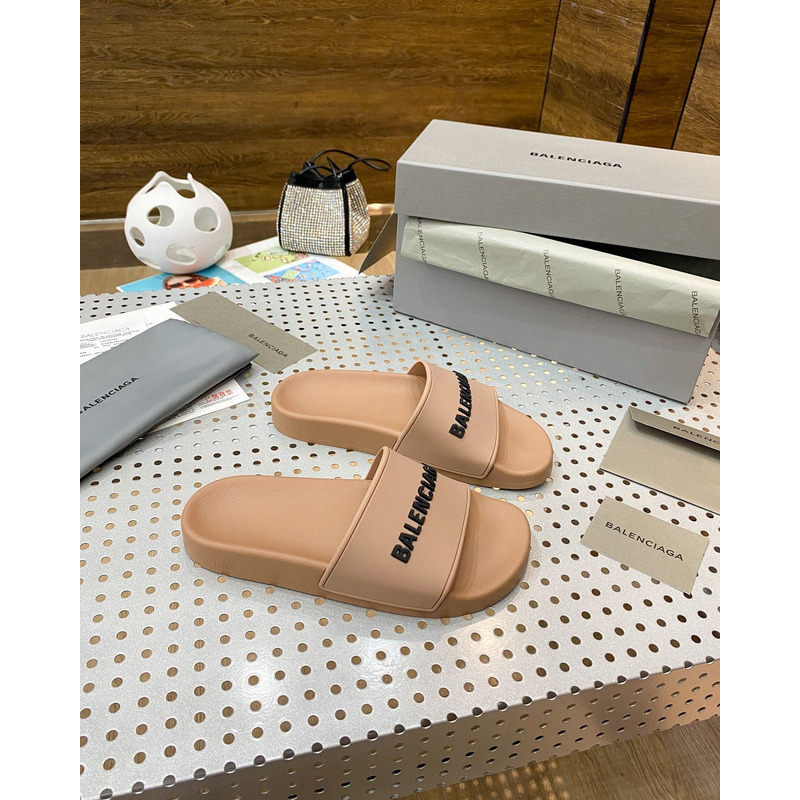 Ba*len*cia*ga pool slide sandal in beige smooth rubber with black 3d Ba*len*cia*ga logo