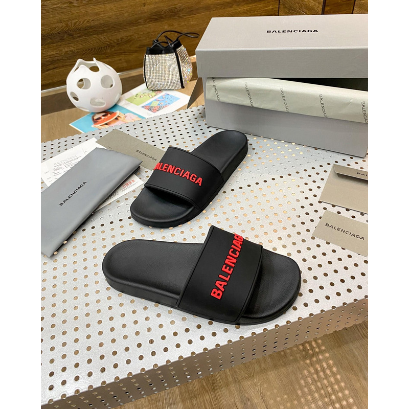 Ba*len*cia*ga pool slide sandal in black rubber with red 3d Ba*len*cia*ga logo