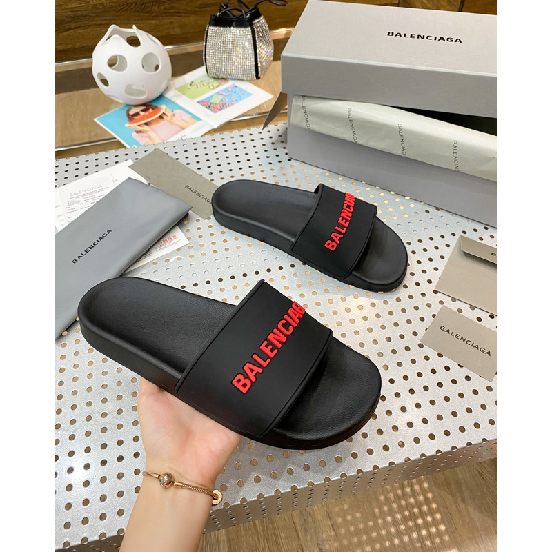 Ba*len*cia*ga pool slide sandal in black rubber with red 3d Ba*len*cia*ga logo