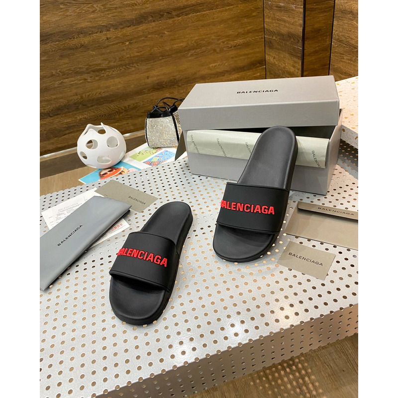 Ba*len*cia*ga pool slide sandal in black rubber with red 3d Ba*len*cia*ga logo