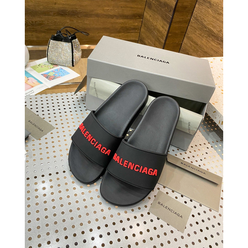 Ba*len*cia*ga pool slide sandal in black rubber with red 3d Ba*len*cia*ga logo