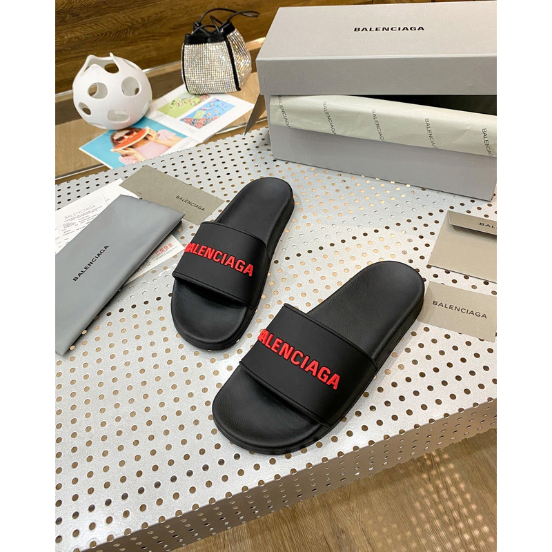 Ba*len*cia*ga pool slide sandal in black rubber with red 3d Ba*len*cia*ga logo