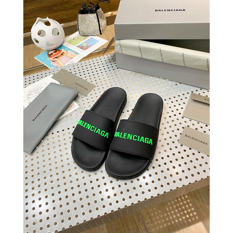 Ba*len*cia*ga pool slide sandal in black rubber with green 3d Ba*len*cia*ga logo