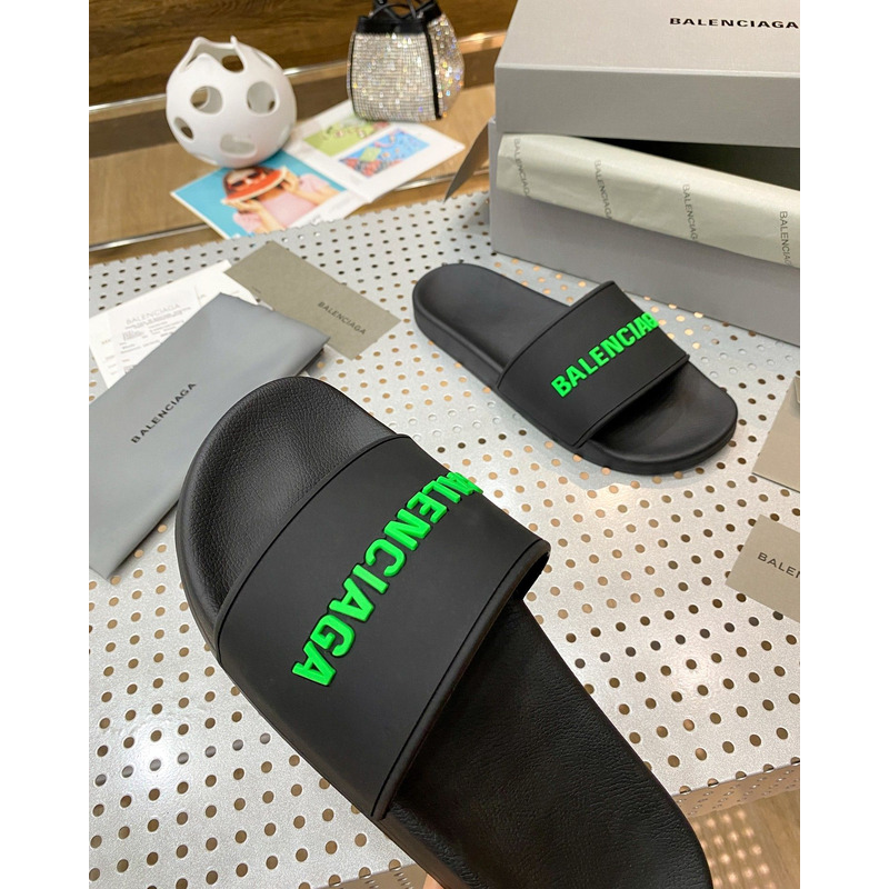 Ba*len*cia*ga pool slide sandal in black rubber with green 3d Ba*len*cia*ga logo