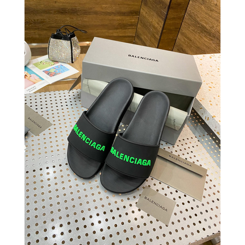 Ba*len*cia*ga pool slide sandal in black rubber with green 3d Ba*len*cia*ga logo