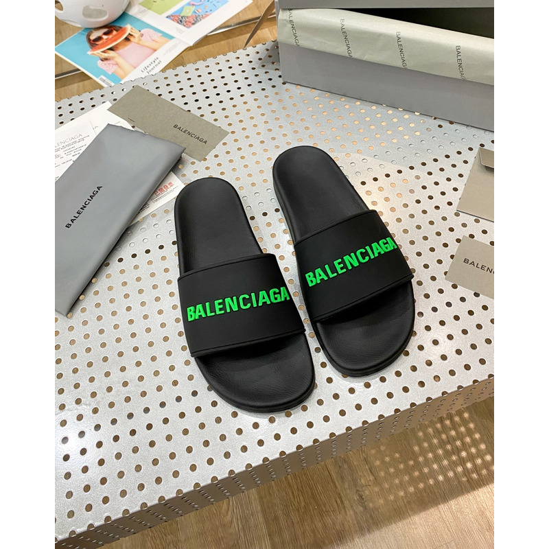 Ba*len*cia*ga pool slide sandal in black rubber with green 3d Ba*len*cia*ga logo