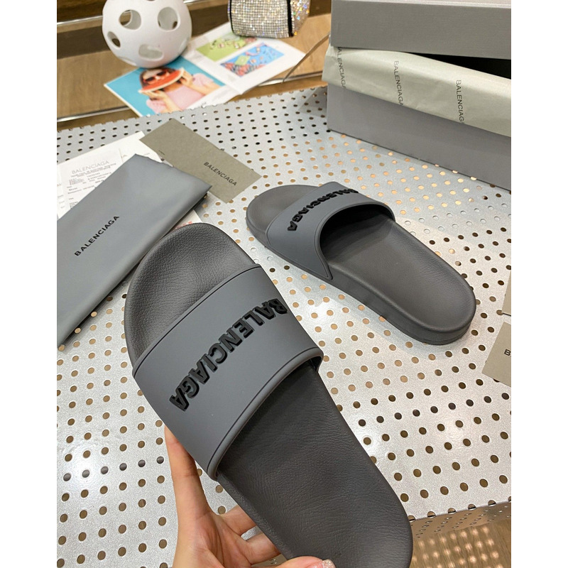 Ba*len*cia*ga pool slide sandal in grey rubber with black 3d Ba*len*cia*ga logo