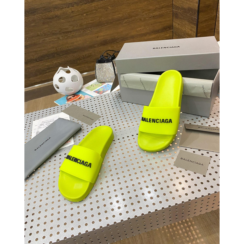 Ba*len*cia*ga pool slide sandal in fluorescent yellow rubber with black 3d Ba*len*cia*ga logo