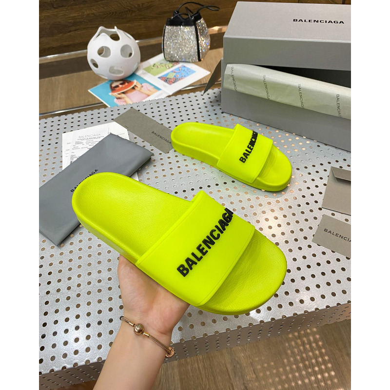 Ba*len*cia*ga pool slide sandal in fluorescent yellow rubber with black 3d Ba*len*cia*ga logo