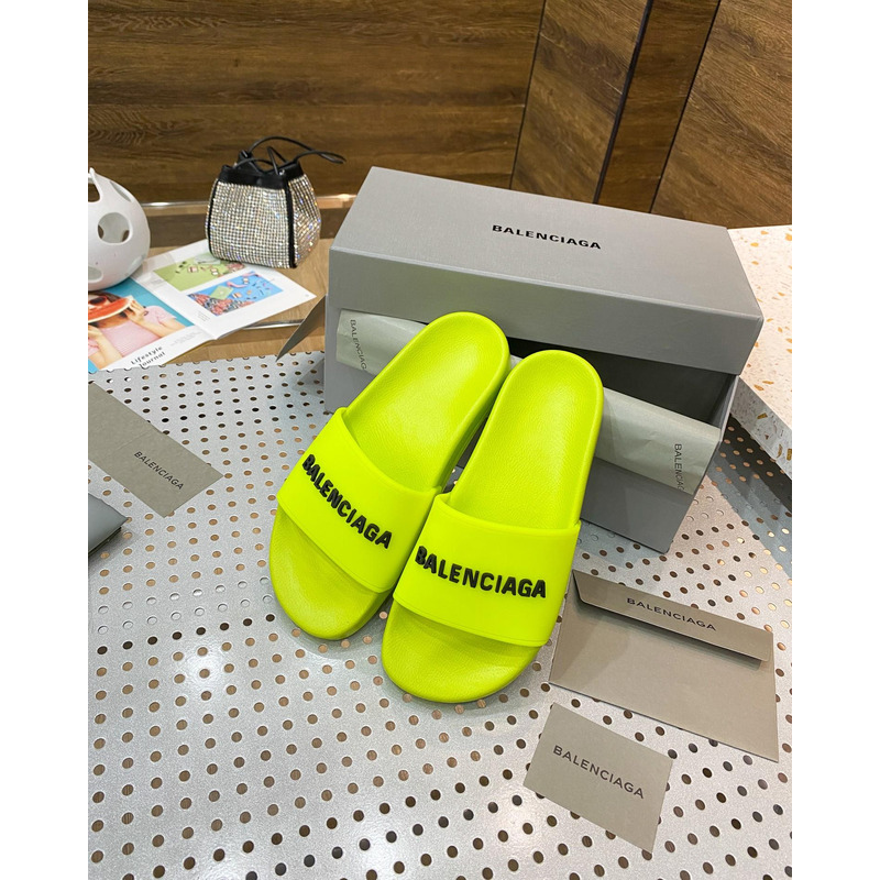 Ba*len*cia*ga pool slide sandal in fluorescent yellow rubber with black 3d Ba*len*cia*ga logo