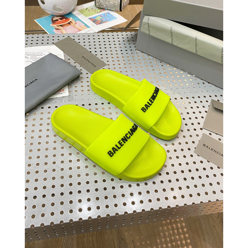 Ba*len*cia*ga pool slide sandal in fluorescent yellow rubber with black 3d Ba*len*cia*ga logo