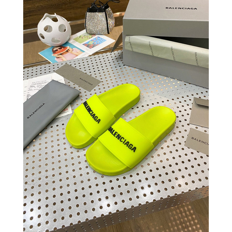 Ba*len*cia*ga pool slide sandal in fluorescent yellow rubber with black 3d Ba*len*cia*ga logo