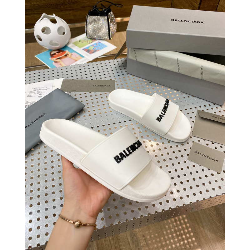 Ba*len*cia*ga pool slide sandal in eggshell white smooth rubber with black 3d Ba*len*cia*ga logo