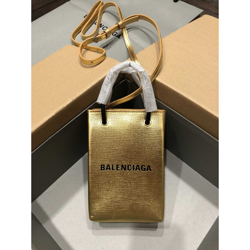 Ba*len*cia*ga textured calfskin logo shopping phone holder bag gold