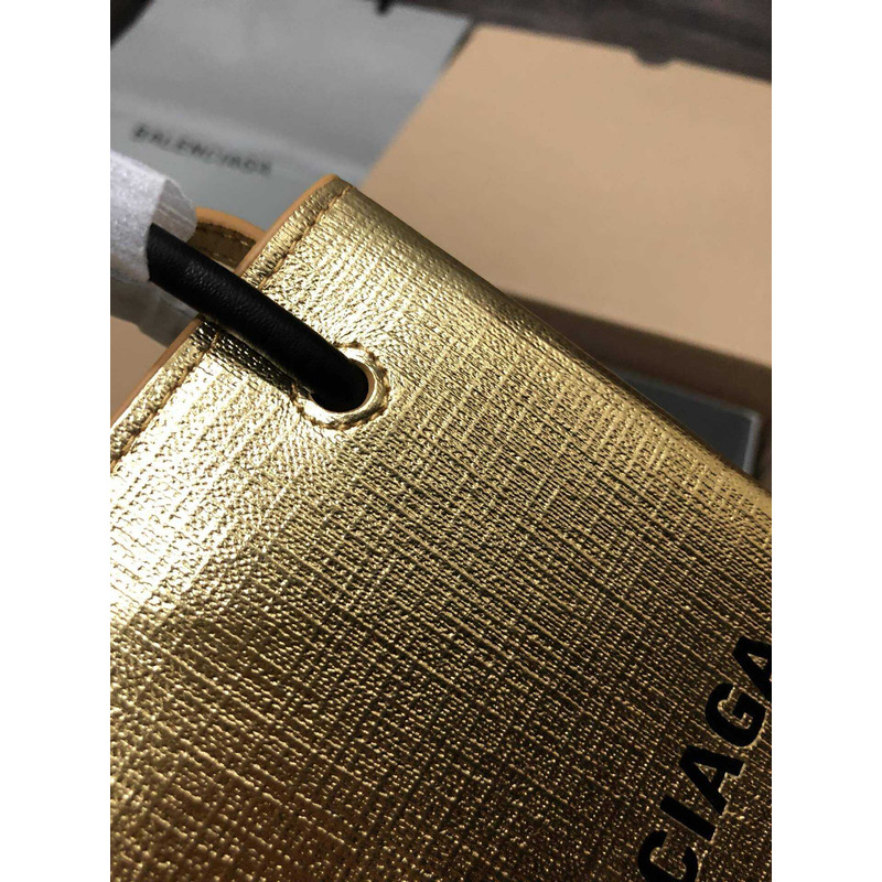 Ba*len*cia*ga textured calfskin logo shopping phone holder bag gold