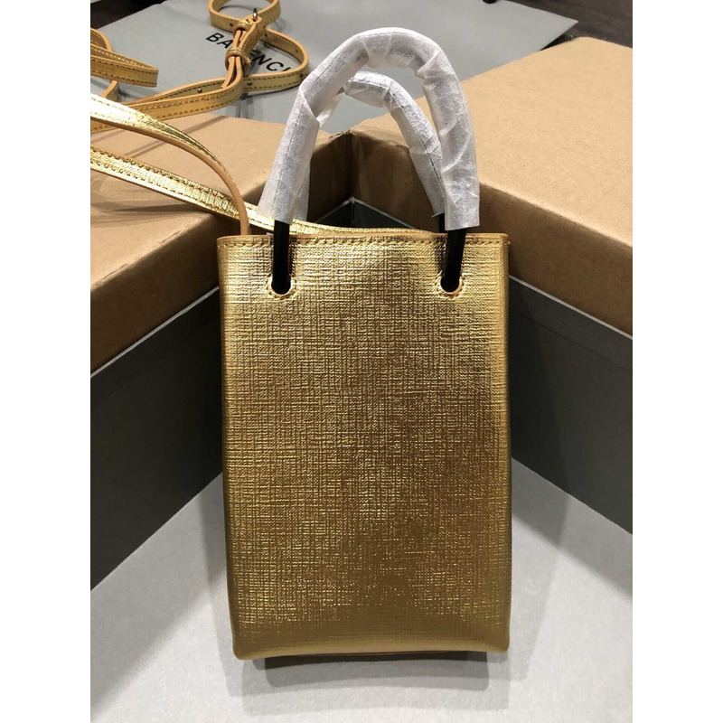 Ba*len*cia*ga textured calfskin logo shopping phone holder bag gold