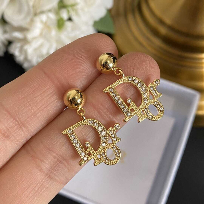 D*or gold letter stud earrings