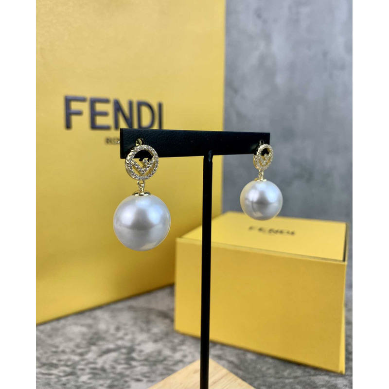 F**di f with pearl earrings