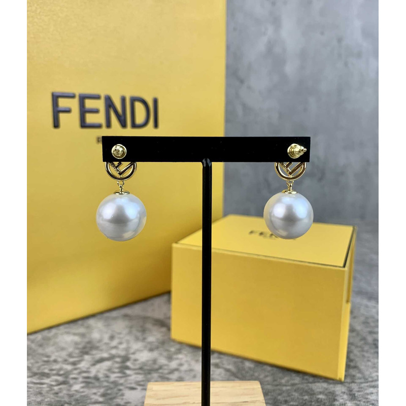 F**di f with pearl earrings