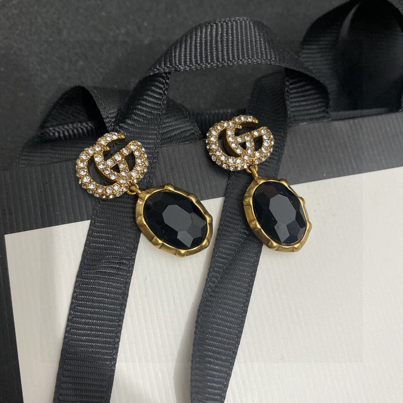 G*u*i crystal earrings gold and black