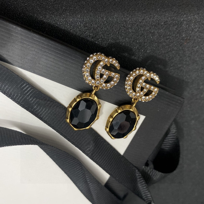 G*u*i crystal earrings gold and black