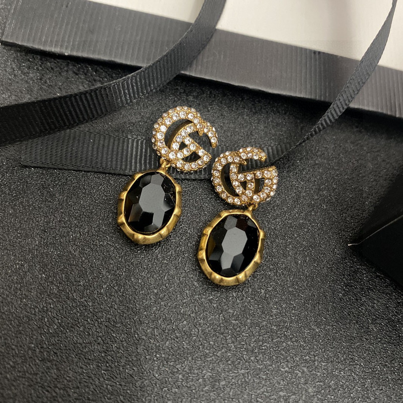 G*u*i crystal earrings gold and black