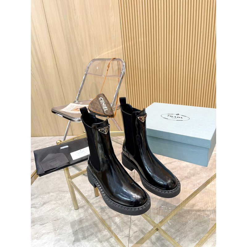 Pra*a metal triangle logo chelsea boots in black